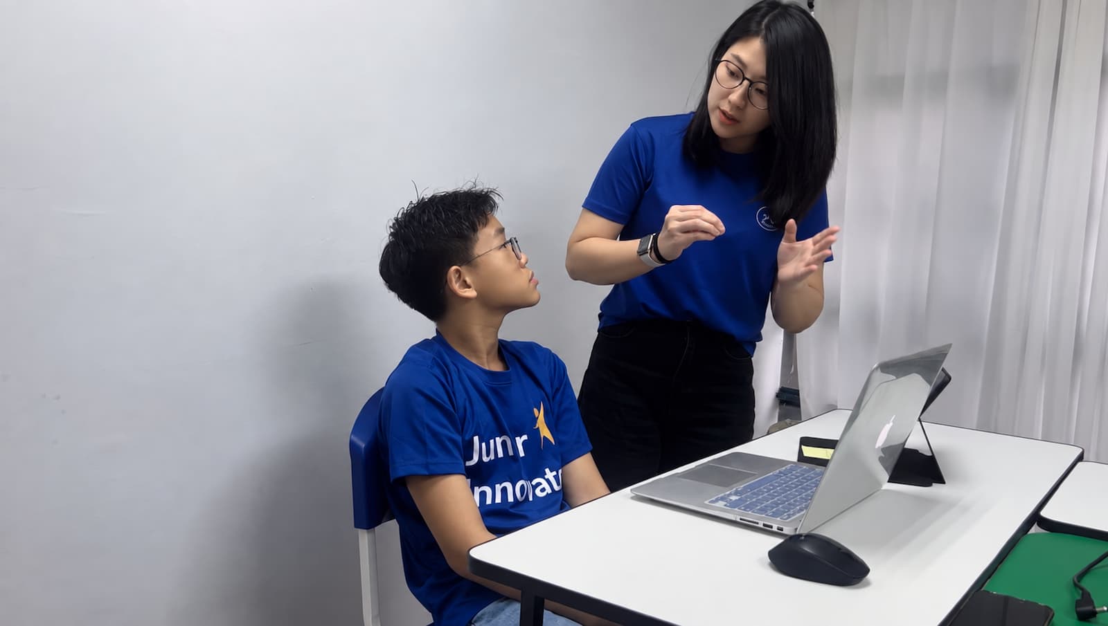 A 21st Mind coach guiding a student